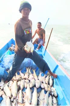 Local fisherman with the day's catch aboard his boat